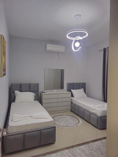 a bedroom with two beds and a mirror at Visi garden house in Valjiosi