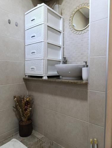 a bathroom with a sink and a mirror at Apartman A&E in Živinice