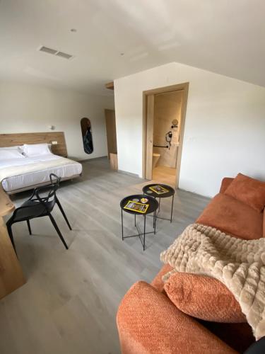 a living room with a bed and a couch at Hotel Chiquín in Tapia de Casariego