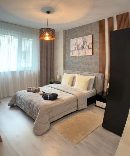 a bedroom with a large bed with a large at Bella Apartment in Ruse