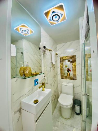 a white bathroom with a toilet and a sink at Hospedaje El Buen Descanso in Salento