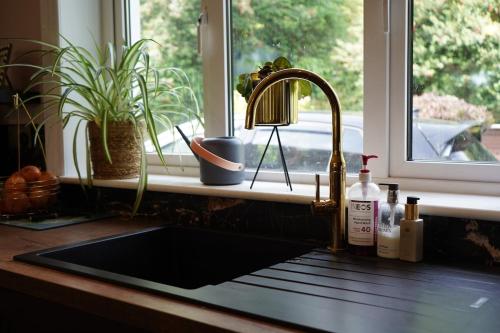 a sink in a kitchen with a window at Kiltumper Lodge in Kilmihil
