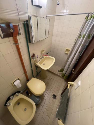 a bathroom with a toilet and a sink at Private room with bathroom in Mendoza
