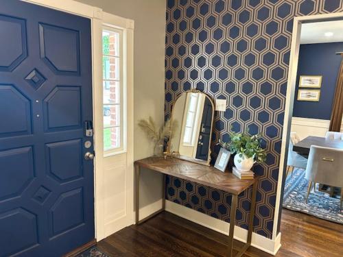 a room with a blue door and a mirror at The Legacy House in Topeka
