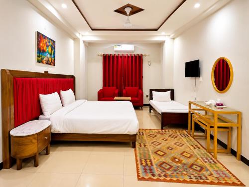 a bedroom with a bed and a red curtain at We Hotels Islamabad Airport in Islamabad