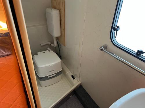 a small bathroom with a toilet and a sink at Karavan u přehrady in Prostějov