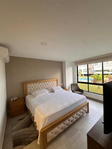 a bedroom with a large bed and a large window at Cocora Stay in Armenia