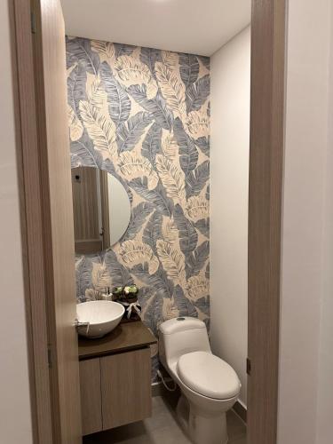 a bathroom with a toilet and a sink and a mirror at Cocora Stay in Armenia