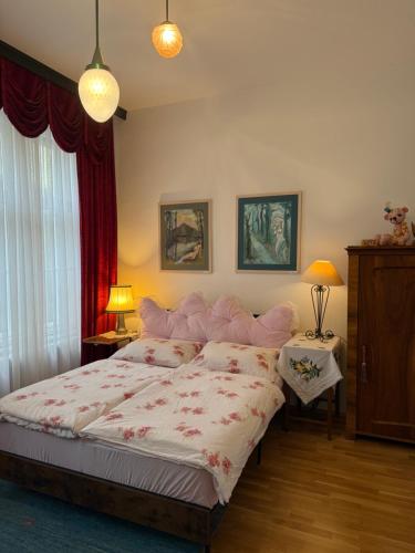 a bedroom with a large bed and a red curtain at Villa Pazelt Top1 in Bad Vöslau