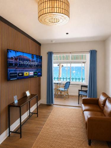 a living room with a couch and a tv at The Edgewater in Avalon