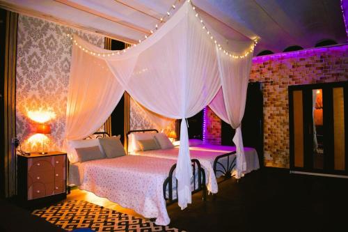 a bedroom with a bed with a canopy at Casa Rural Julio in Terriente