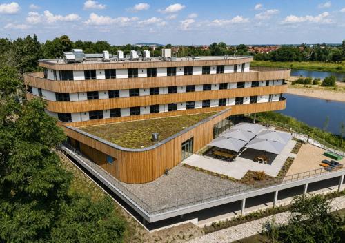an overhead view of a building with a green roof at Das ELB Hotel & Restaurant in Magdeburg