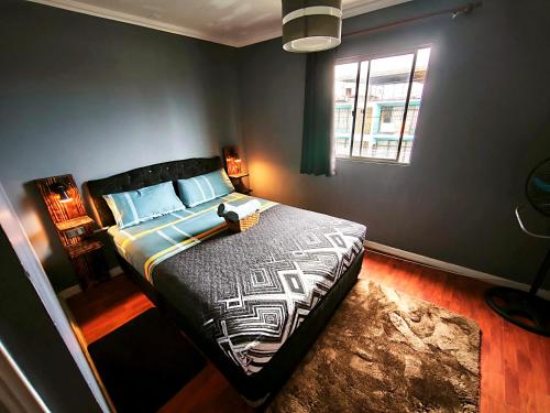 a bedroom with a bed and a window at Donde PATO in Iquique