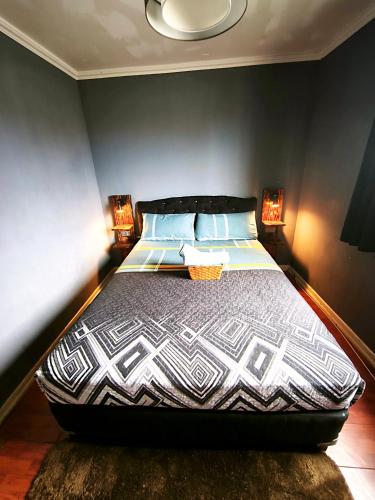 a bedroom with a large bed with two lamps at Donde PATO in Iquique