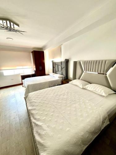a hotel room with two beds in a room at Luxury Duplex Terrace and Grill in Ica