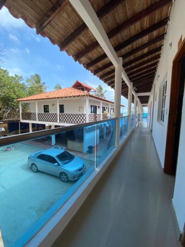 a car parked on the balcony of a building at hostal EMBAMAR in Palomino