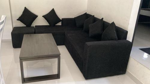 a black couch and a table in a living room at Nisansala Villa in Matara