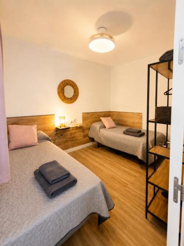 a room with two beds and a mirror at La casa de curro in Arcos de la Frontera