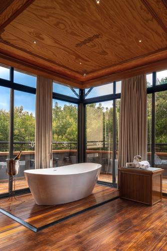 a large bath tub in a room with windows at Hotel Parque España in Mexico City