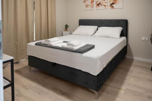 a bed with two towels on it in a bedroom at Villa Kleopatra in Međugorje