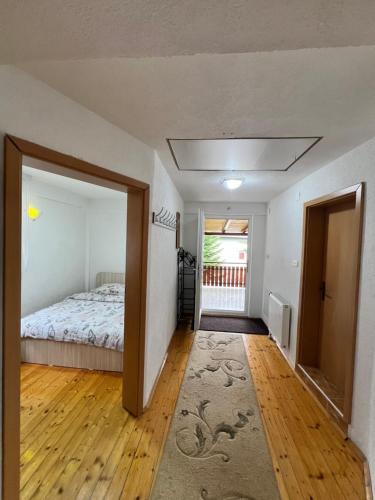 an empty room with a bed and a hallway at Villa JETI in Tetovo