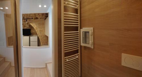 a room with a door and a wall with a television at Il Rifugio del Re in Manfredonia