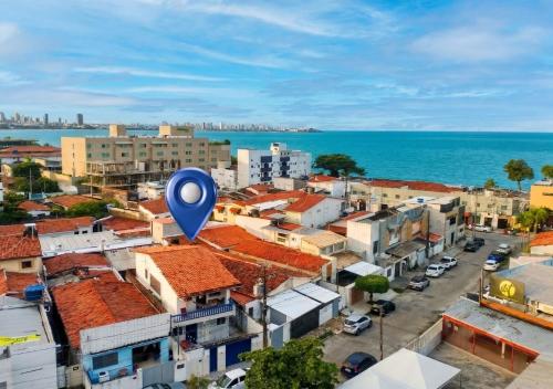 a city with a blue balloon in front of the ocean at Armorial Hostel in João Pessoa