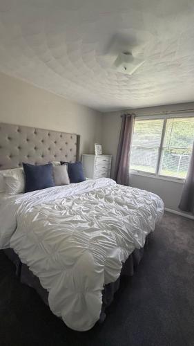a bedroom with a large white bed with blue pillows at The Massillon Retreat! in Massillon