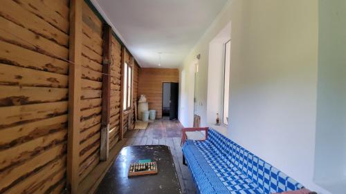 a hallway with a blue bench and a wooden wall at Guest House DEDA TINA in Mestia