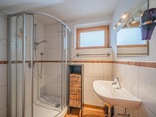 a bathroom with a sink and a shower and a toilet at IndieBerge in Mittersill