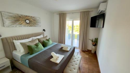 a bedroom with a bed with two plates on it at Apartments Oxygen in Račišće