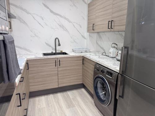 a kitchen with a sink and a washing machine at Sunderland Central 2BR Apartments in Sunderland