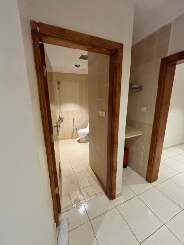 a bathroom with a shower and a toilet in a room at Alassaf 304 in Sīdī Ḩamzah