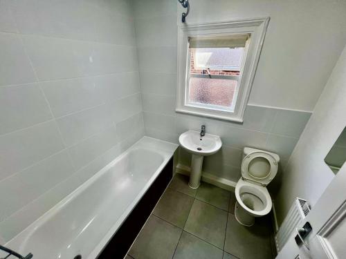 a bathroom with a tub and a toilet and a sink at East Croydon Train Station in Croydon
