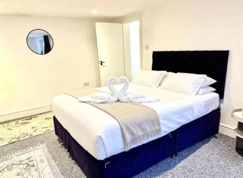 a bedroom with a large bed with a towel on it at St Leonards in Hollington