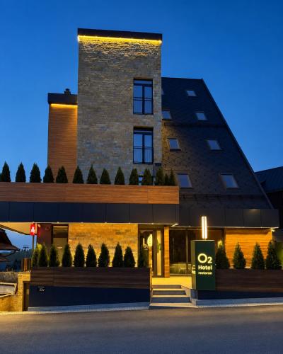 a building with a sign in front of it at Hotel O2 Tornik in Ribnica