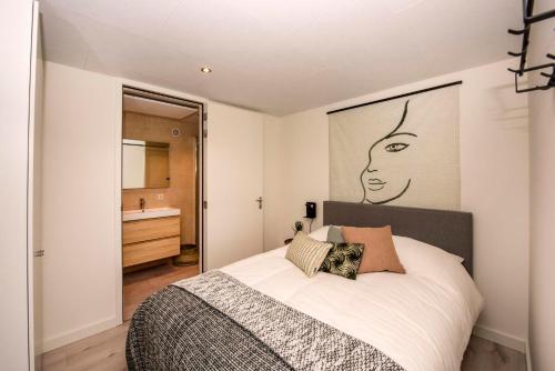 a bedroom with a bed with a large picture on the wall at Forest Cube 5 persons #702 in Maasbree
