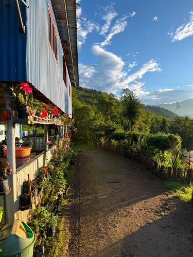 a building with flowers on the side of it at Chintapu Homestay In Maipokhari, Sandakpur Ilam in Ilām