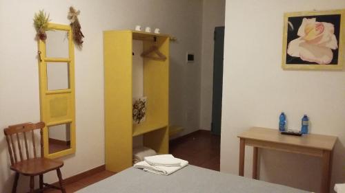 a room with a table and a yellow cabinet at Agriturismo Boschi in Reggiolo
