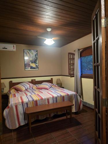 a bedroom with a bed and a wooden ceiling at Eco Pousada Eldorado Lumiar in Lumiar