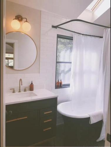 a white bathroom with a sink and a mirror at The Land - Retreat Center In Beautiful Nature - Bay Area Northern California in Philo