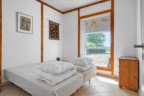 a bedroom with two beds and a window at 6048-Stege-Kostervej-48 in Stege