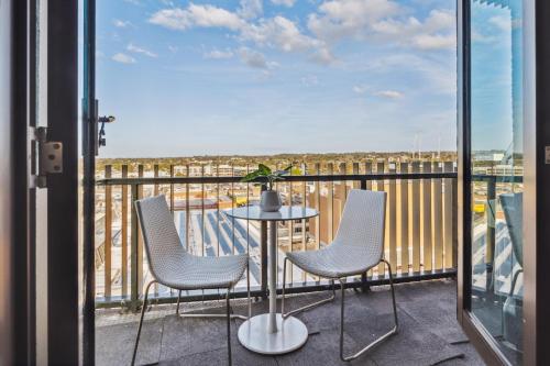 a balcony with a table and chairs and a view at Seaside Studio Apartment in Frankston, Melbourne in Frankston