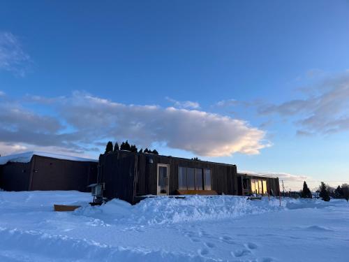 a building in the snow with snow around it at Hokkaido Zen Cabin in Bibai