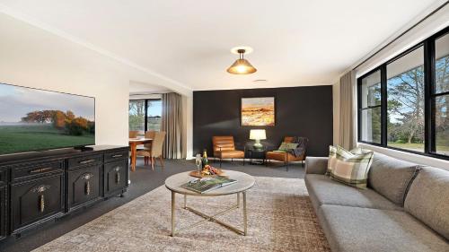 a living room with a couch and a table at Mirambeena in Berrima