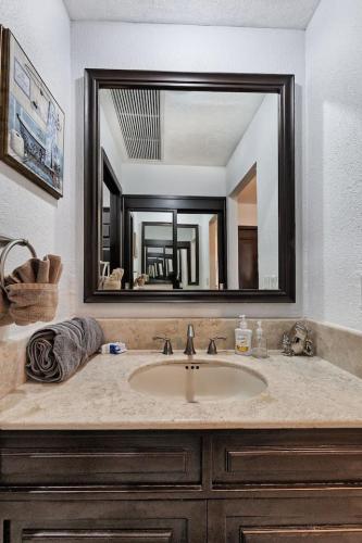 a bathroom with a sink and a large mirror at Ground Floor Sonoran Sea 112-W in Puerto Peñasco