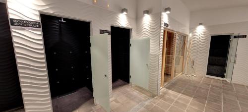 a row of black doors in a room with a tile floor at Hotel Villa del Mar in Benidorm