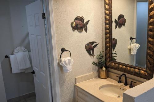 a bathroom with a sink and a mirror at Princesa de Penasco B208 - Family Beach Getaway in Puerto Peñasco