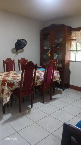 a dining room with a table and chairs and a phone at Las Colinas in León