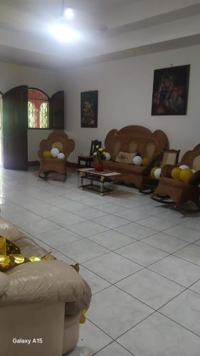 a living room with couches and chairs in a room at Las Colinas in León